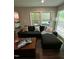 Inviting living room with dark sofa, patterned pillows, and access to outdoor deck at 80 Stoneridge Rd, Durham, NC 27705