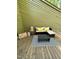 Outdoor patio features modern furniture, a stylish rug, and decorative accents at 80 Stoneridge Rd, Durham, NC 27705