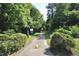 Paved walking path bordered by green foliage and trees, inviting residents to enjoy the outdoors at 80 Stoneridge Rd, Durham, NC 27705