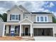 Charming two-story home with stone accents, a welcoming porch, and an attached two-car garage at 820 Emerald Bay Cir # 762, Raleigh, NC 27610
