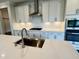 Modern kitchen with white cabinets, stainless steel appliances, and a gas cooktop on the center island at 820 Emerald Bay Cir # 762, Raleigh, NC 27610