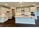 Bright kitchen featuring white cabinets, stainless steel appliances, and a spacious center island with sink at 820 Emerald Bay Cir # 762, Raleigh, NC 27610
