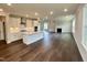 Open-concept living area with hardwood floors, a fireplace, and a seamless transition to the kitchen at 820 Emerald Bay Cir # 762, Raleigh, NC 27610