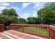 A wooden back deck is surrounded by a fenced yard and trees at 919 Chester St, Durham, NC 27701