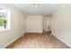 Bedroom with hardwood floors, ceiling light and access to bathroom at 919 Chester St, Durham, NC 27701