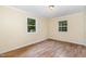 Bedroom with hardwood floors and natural light from the windows at 919 Chester St, Durham, NC 27701