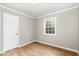 Bedroom featuring a hardwood floor, a door, and a window at 919 Chester St, Durham, NC 27701