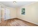 Bedroom featuring hardwood floors, ceiling light, and window view at 919 Chester St, Durham, NC 27701
