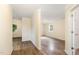 Hallway showing access to different rooms with modern hardwood flooring at 919 Chester St, Durham, NC 27701