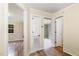 Hallway featuring wood floors and multiple doorways at 919 Chester St, Durham, NC 27701