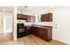 A kitchen with sleek, dark appliances, and laminate flooring at 919 Chester St, Durham, NC 27701