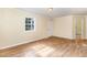 Spacious living room featuring updated floors, neutral paint, and ample natural light at 919 Chester St, Durham, NC 27701