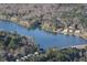 An aerial view of the beautiful lake featuring community homes along the shoreline at 101 Turnberry Ln, Cary, NC 27511
