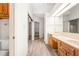 Bright bathroom featuring a double vanity, ample storage, and a well-lit mirror at 101 Turnberry Ln, Cary, NC 27511