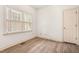 Well-lit bedroom with wood floors, large window, and neutral walls at 101 Turnberry Ln, Cary, NC 27511