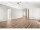 Open bedroom with ceiling fan, skylight, and adjoining bathroom at 101 Turnberry Ln, Cary, NC 27511
