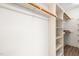 Spacious walk-in closet with built-in shelving and wooden rods for organized storage at 101 Turnberry Ln, Cary, NC 27511