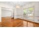Formal dining room featuring hardwood floors, decorative chandelier and large windows at 101 Turnberry Ln, Cary, NC 27511