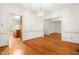 Open dining room with hardwood floors, chandelier, and seamless flow into the kitchen at 101 Turnberry Ln, Cary, NC 27511