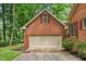 Spacious detached two-car garage with brick exterior and driveway, offering ample parking at 101 Turnberry Ln, Cary, NC 27511