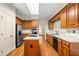 Bright kitchen with an island cooktop, stainless steel fridge, wooden cabinets, and natural light at 101 Turnberry Ln, Cary, NC 27511