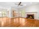Spacious living room with a fireplace, hardwood floors, bright natural light, and neutral paint at 101 Turnberry Ln, Cary, NC 27511
