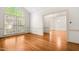 Bright living room boasts hardwood floors, crown molding, and a large window for natural light at 101 Turnberry Ln, Cary, NC 27511