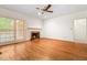 Bright living room with a fireplace, hardwood floors, large windows, and neutral paint at 101 Turnberry Ln, Cary, NC 27511