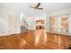 Open living area with hardwood floors, staircase, fireplace, and bright natural lighting at 101 Turnberry Ln, Cary, NC 27511