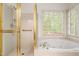 Main bathroom with glass-enclosed shower and jetted tub at 101 Turnberry Ln, Cary, NC 27511