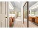 Bright main bathroom with double sinks, glass shower door, and skylight at 101 Turnberry Ln, Cary, NC 27511