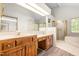 Bright main bathroom with double sinks, glass shower door, and skylight at 101 Turnberry Ln, Cary, NC 27511