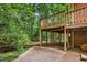 Under-deck patio with support beams provides shaded space for relaxing and enjoying the wooded backyard at 101 Turnberry Ln, Cary, NC 27511
