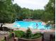 Relax by the community pool, featuring a slide, plenty of seating, and shaded areas for sunny days at 101 Turnberry Ln, Cary, NC 27511
