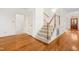Elegant staircase featuring wood and carpet, with a charming open door at 101 Turnberry Ln, Cary, NC 27511