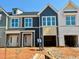 New townhomes featuring modern architecture, white-trimmed windows, and attached garages at 103 Ripple Way # 210, Clayton, NC 27520