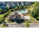 Community clubhouse and pool with lounge chairs surrounded by lush landscaping at 105 Blue Prince Trl, Holly Springs, NC 27540