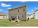 View of the home's backyard featuring a patio and lush lawn at 111 S Rose Hill Dr, Clayton, NC 27520