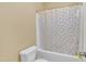 Bathroom featuring a bathtub and shower with rainbow curtain and toilet at 111 S Rose Hill Dr, Clayton, NC 27520