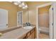 Bathroom featuring granite counters, a framed mirror, vanity, and a door leading to the shower and toilet area at 111 S Rose Hill Dr, Clayton, NC 27520