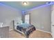 Bedroom featuring gray walls, carpet floors, a window, and an accent light at 111 S Rose Hill Dr, Clayton, NC 27520