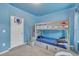 Blue bedroom featuring a bunkbed with under-bed storage, carpet floors, and blue led lighting at 111 S Rose Hill Dr, Clayton, NC 27520