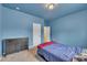 Bedroom featuring blue walls, carpet floors, a window, and a dark dresser at 111 S Rose Hill Dr, Clayton, NC 27520