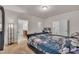 Comfortable bedroom featuring a plush bed, a wall-mounted TV, and an open doorway to an office space at 111 S Rose Hill Dr, Clayton, NC 27520