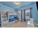 Blue bedroom featuring a bunkbed with under-bed storage, carpet floors, and a window at 111 S Rose Hill Dr, Clayton, NC 27520