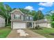 Exterior view of a two story house with solar panels and a green lawn and blue skies at 111 S Rose Hill Dr, Clayton, NC 27520