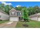Exterior view of a two story house with solar panels and a green lawn and blue skies at 111 S Rose Hill Dr, Clayton, NC 27520