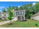 Exterior view of a two story house with solar panels and a green lawn and blue skies at 111 S Rose Hill Dr, Clayton, NC 27520