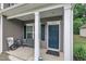 Inviting front porch features a bench, blue door, and classic white columns at 111 S Rose Hill Dr, Clayton, NC 27520