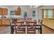Kitchen and dining area shows table set for a meal with wood cabinets in the background at 111 S Rose Hill Dr, Clayton, NC 27520